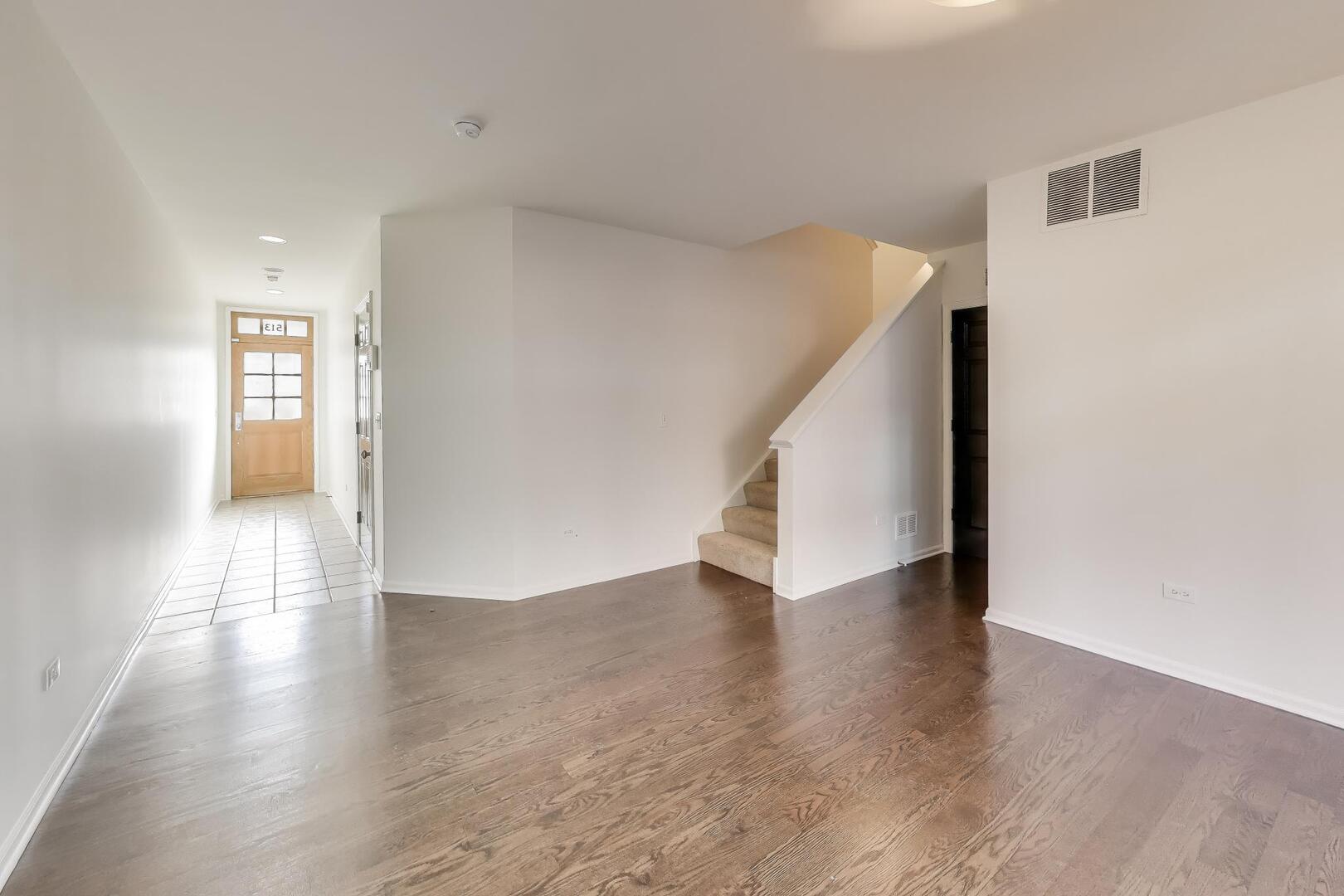 513 Grove Lane Forest Park, IL 60130 - Photo 7 of 34 a view of a hallway with wooden floor and stairs