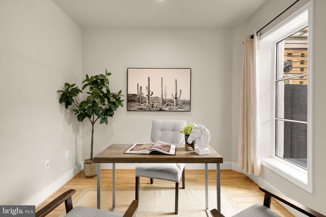 a view of a workspace room with furniture