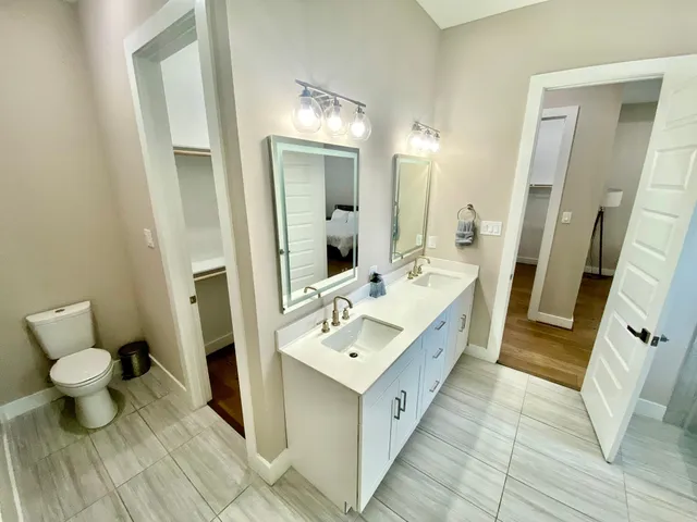 a bathroom with a double vanity sink and mirror