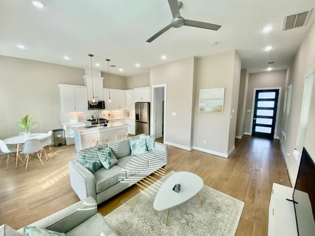 a living room with furniture and kitchen view