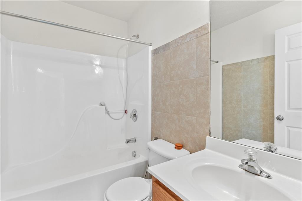 665 Roxford Lane Northeast Buford, GA 30518 - Photo 15 of 29 a bathroom with a sink toilet and shower