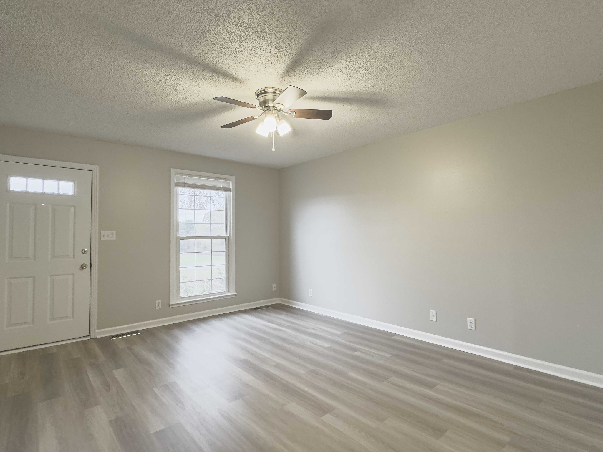 610 Sango Road Clarksville, TN 37043 - Photo 5 of 21 an empty room with wooden floor fan and windows