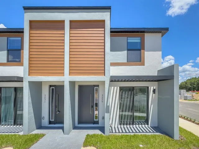 a view of a house with backyard and porch