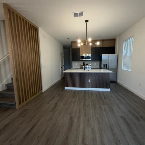 a view of a livingroom with furniture wooden floor and chandelier