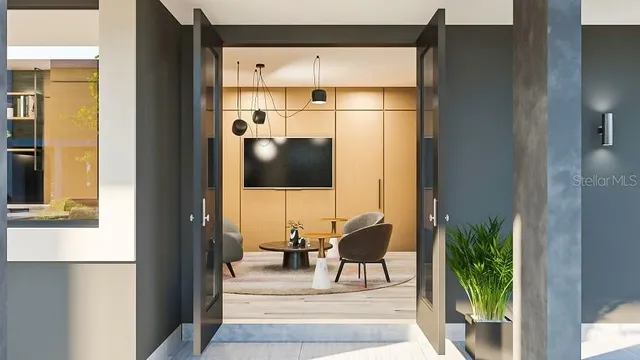 a living room with furniture and a potted plant next to a window