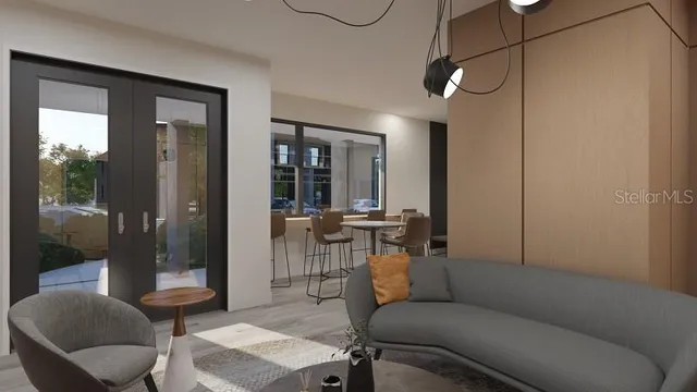 a living room with furniture and a glass door