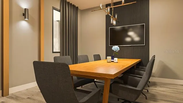 a view of a dining room with furniture and wooden floor