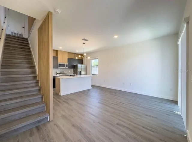 a view of kitchen with cabinets and wooden floor