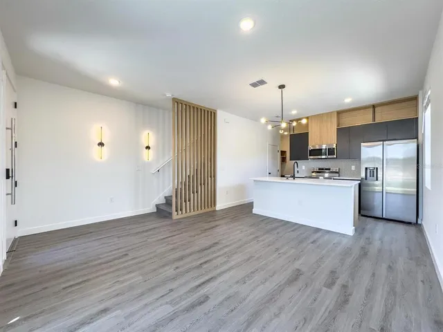 a view of kitchen with granite countertop cabinets and wooden floor