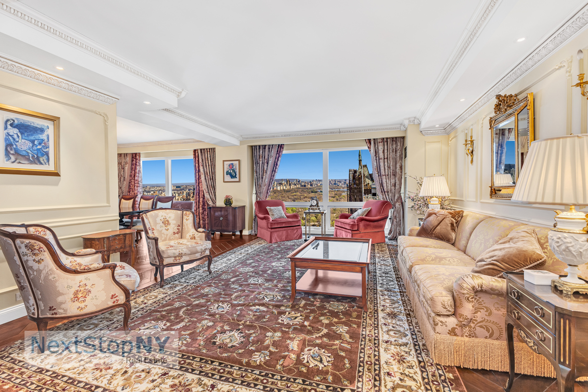 721 5th Avenue, Unit 48K Manhattan, NY 10022 - Photo 1 of 15 a living room with furniture and a dining table