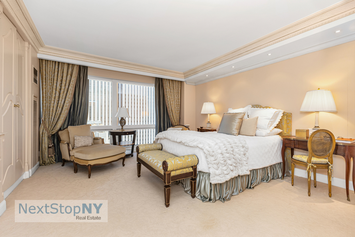 721 5th Avenue, Unit 48K Manhattan, NY 10022 - Photo 8 of 15 a bedroom with a bed chair and a window