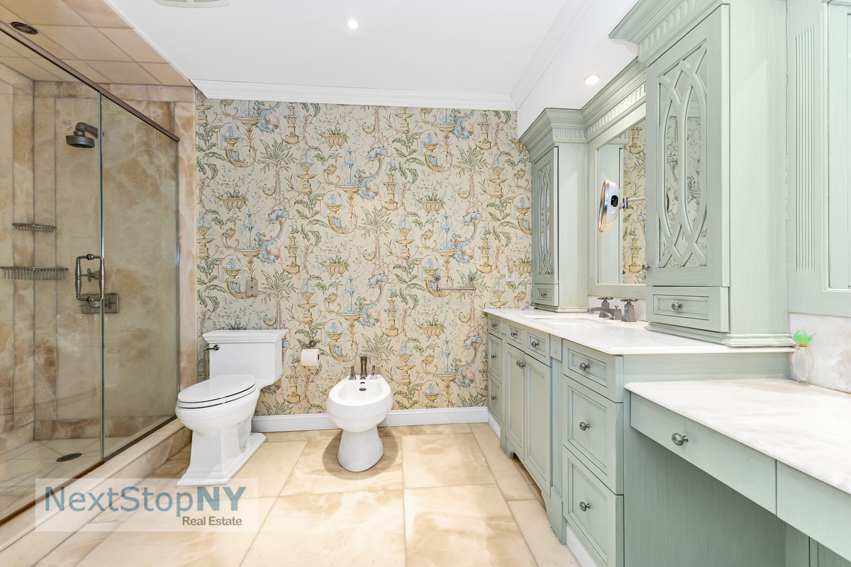 721 5th Avenue, Unit 48K Manhattan, NY 10022 - Photo 9 of 15 a bathroom with a sink toilet and shower