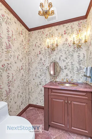 a bathroom with a tub a sink and mirror