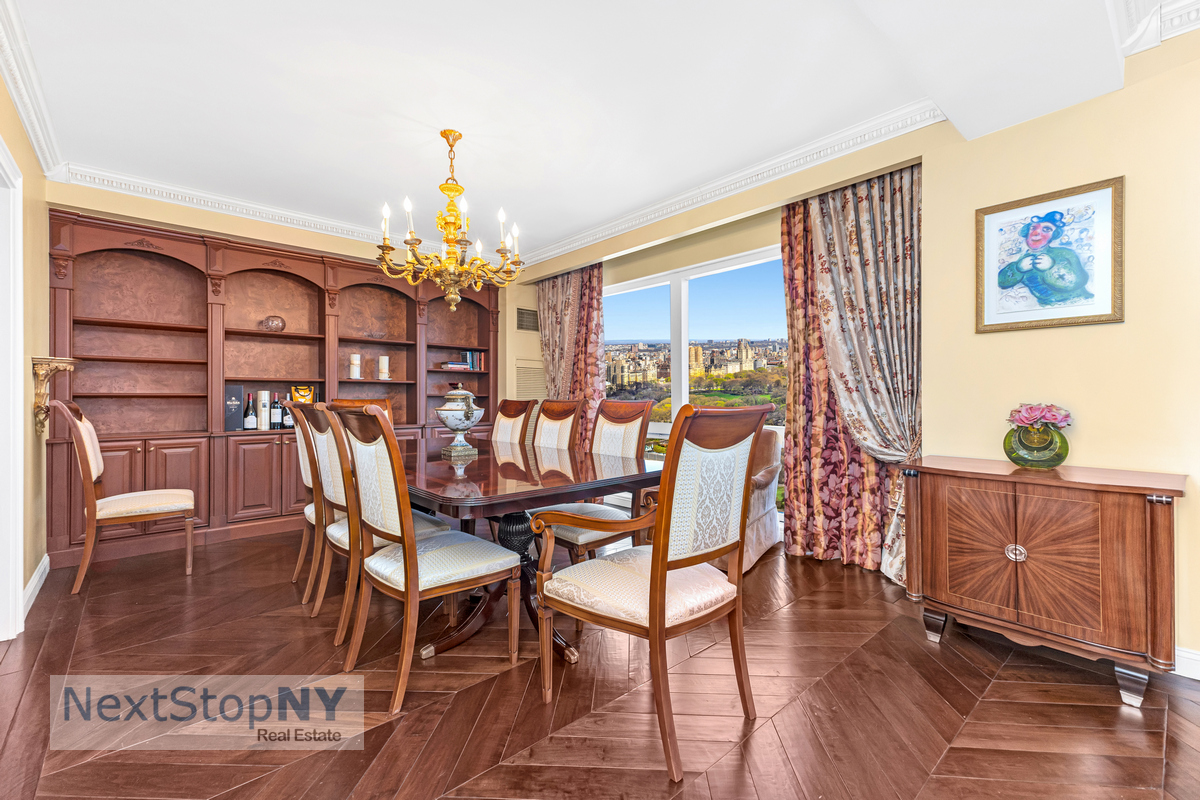 721 5th Avenue, Unit 48K Manhattan, NY 10022 - Photo 4 of 15 a dining room with furniture a chandelier and wooden floor