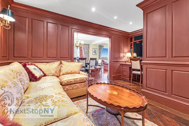 a dining room with furniture a chandelier and wooden floor