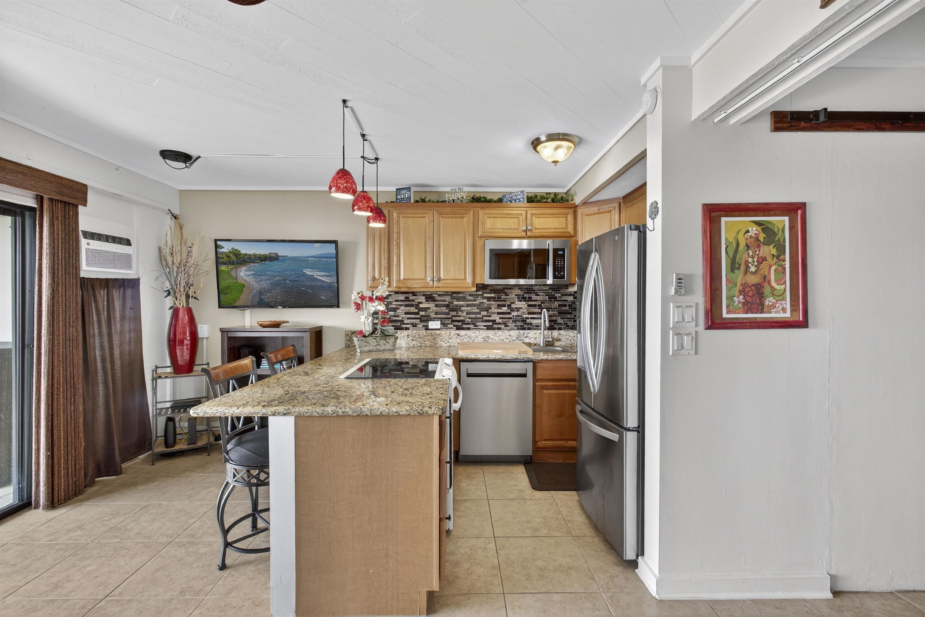4435 Lower Honoapiilani Road, Unit 111 Lahaina, HI 96761 - Photo 12 of 50 a kitchen that has a lot of counter space and a refrigerator