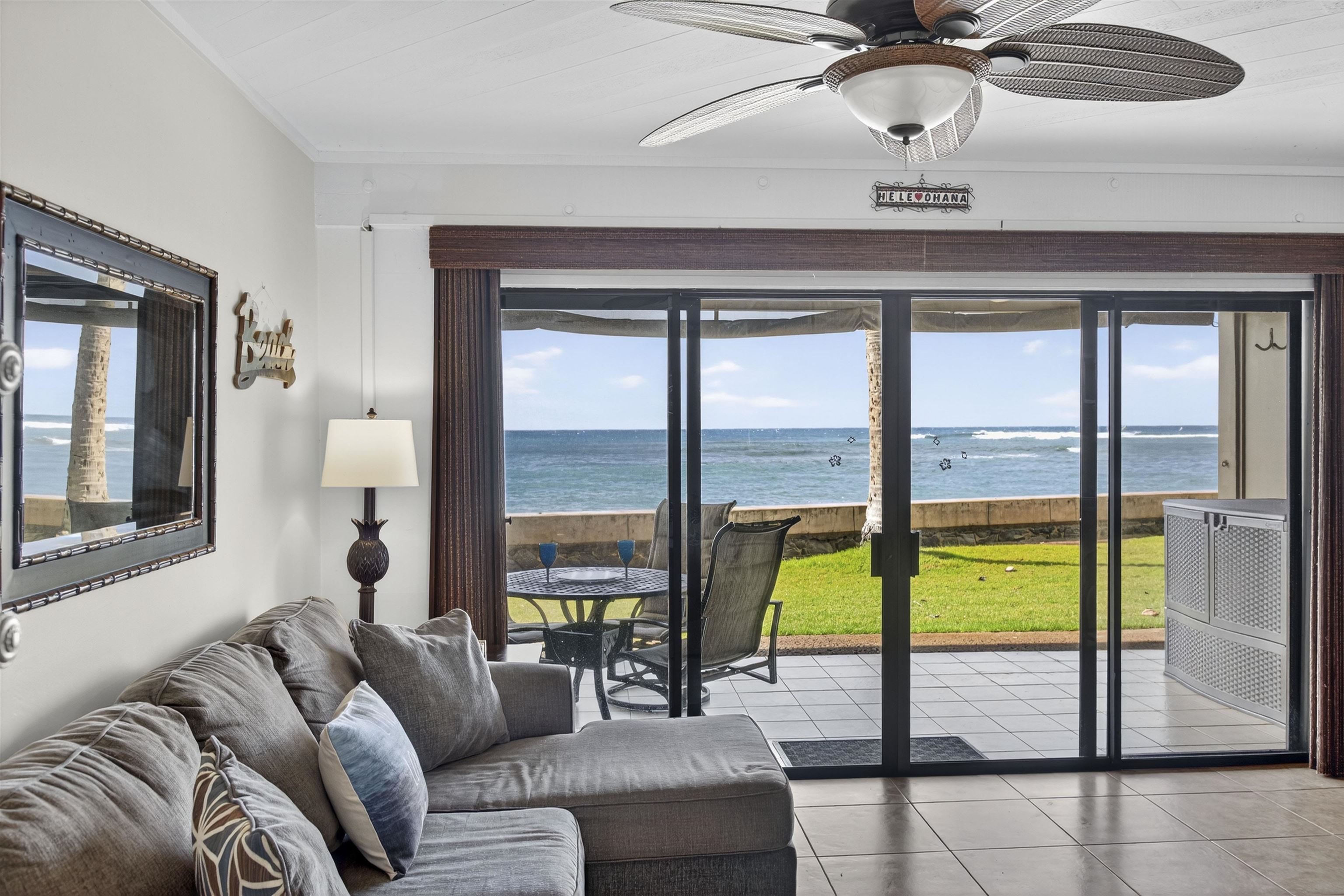 4435 Lower Honoapiilani Road, Unit 111 Lahaina, HI 96761 - Photo 13 of 50 a living room with furniture and a floor to ceiling window