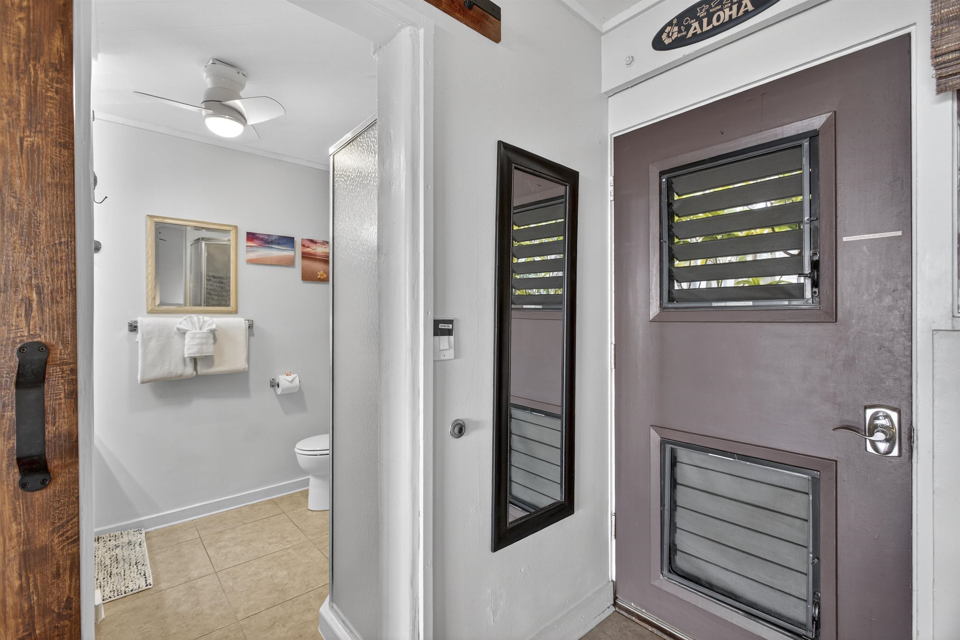 4435 Lower Honoapiilani Road, Unit 111 Lahaina, HI 96761 - Photo 36 of 50 a bathroom with a toilet a sink and a mirror