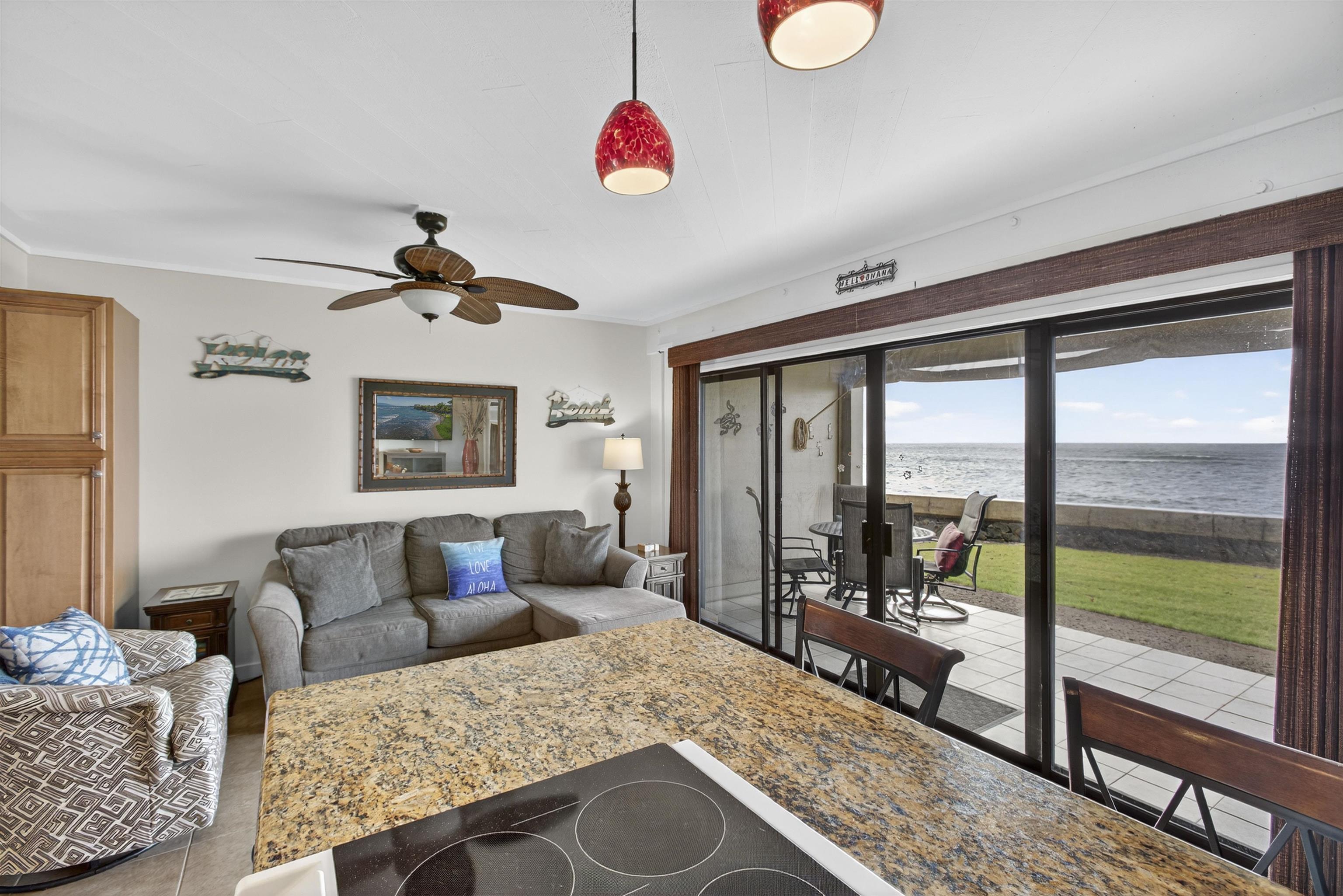 4435 Lower Honoapiilani Road, Unit 111 Lahaina, HI 96761 - Photo 4 of 50 a living room with furniture and a floor to ceiling window