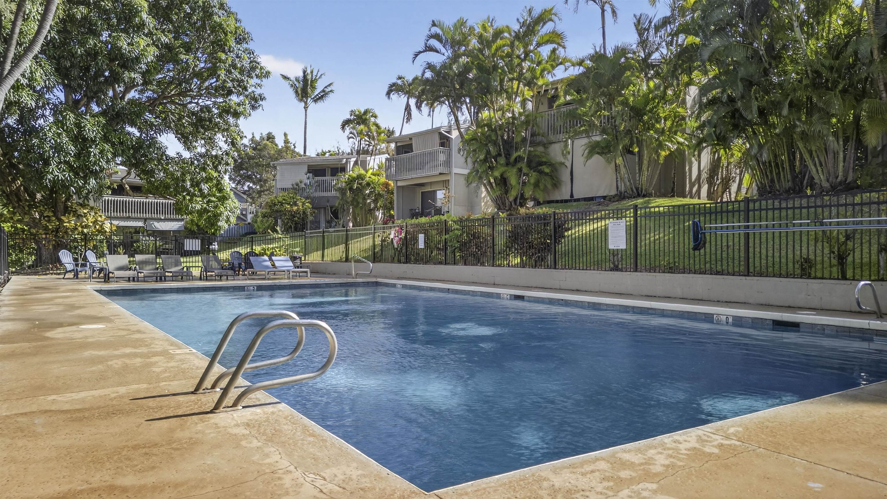 4435 Lower Honoapiilani Road, Unit 111 Lahaina, HI 96761 - Photo 46 of 50 a swimming pool with outdoor seating and yard