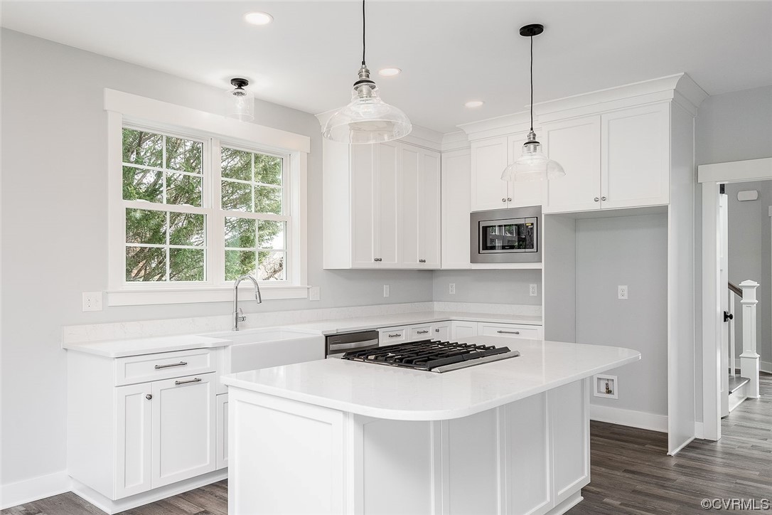 3154 Cider House Road Toano, VA 23168 - Photo 15 of 36 a kitchen with a sink a stove a microwave and white cabinets