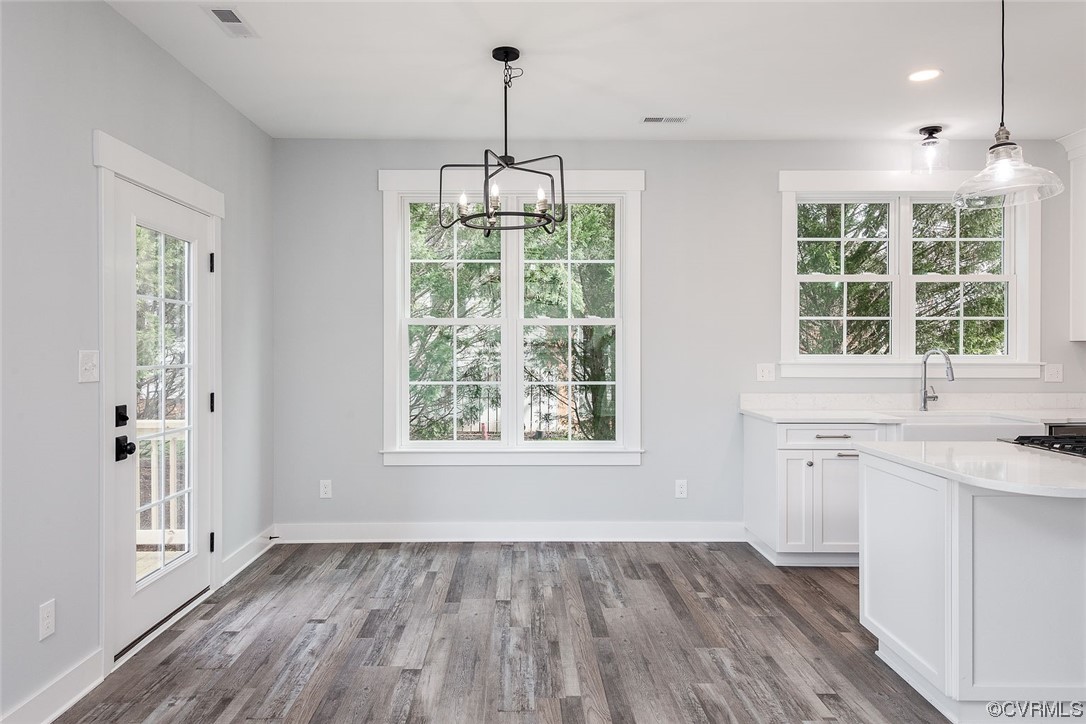 3154 Cider House Road Toano, VA 23168 - Photo 18 of 36 an empty room with wooden floor and windows