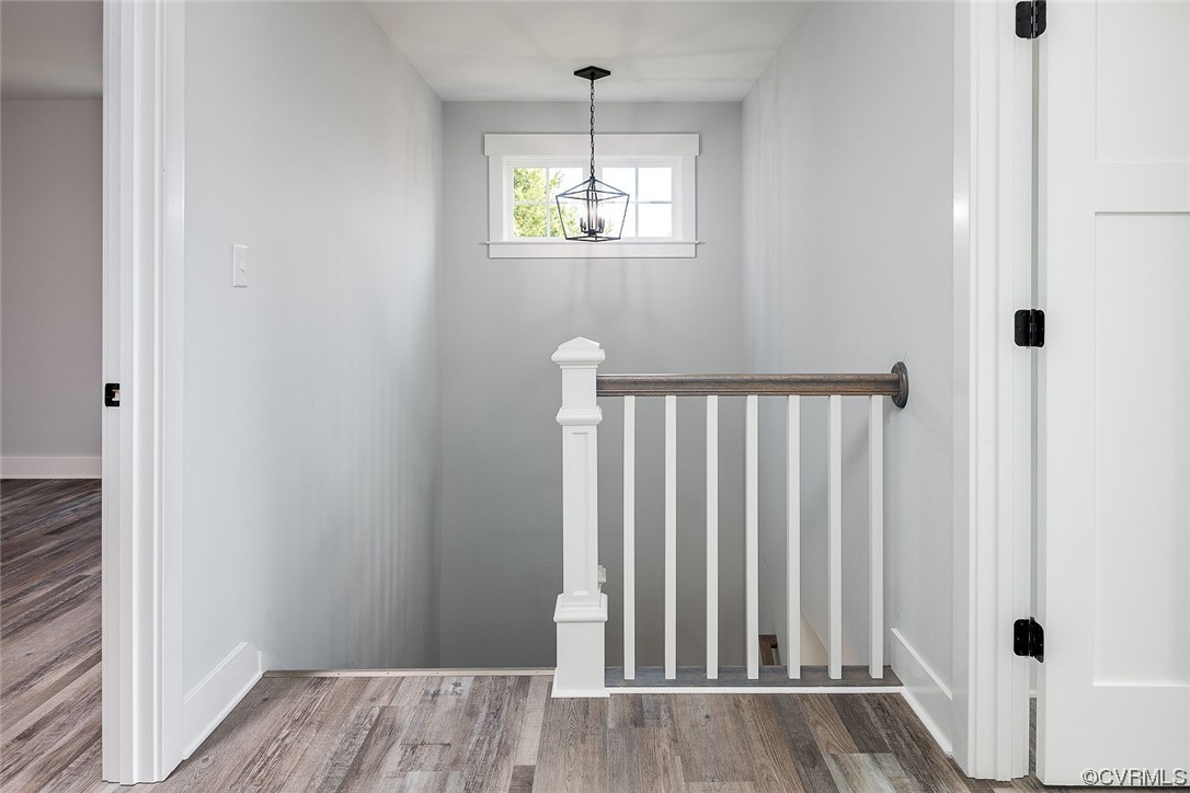 3154 Cider House Road Toano, VA 23168 - Photo 26 of 36 a view of a hallway with wooden floor and staircase
