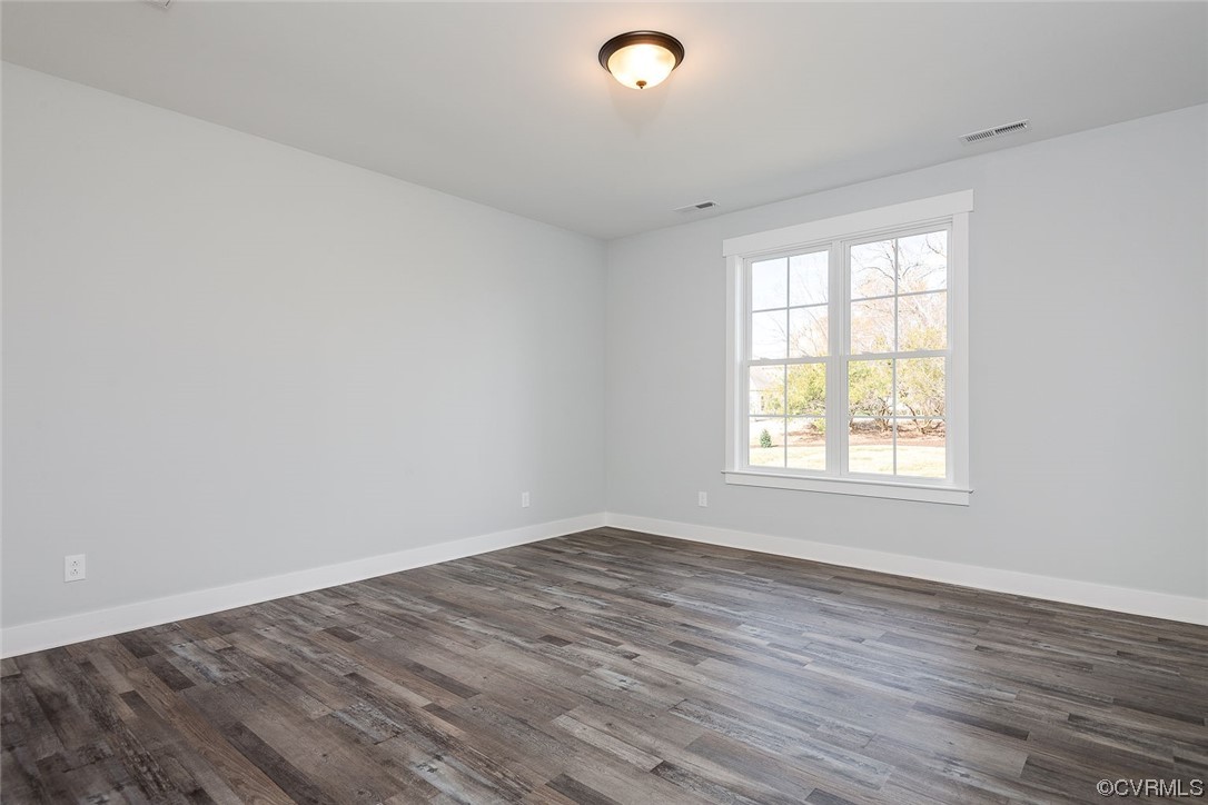3154 Cider House Road Toano, VA 23168 - Photo 27 of 36 an empty room with wooden floor and windows