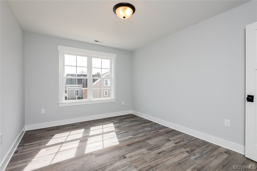 3154 Cider House Road Toano, VA 23168 - Photo 28 of 36 an empty room with wooden floor and windows