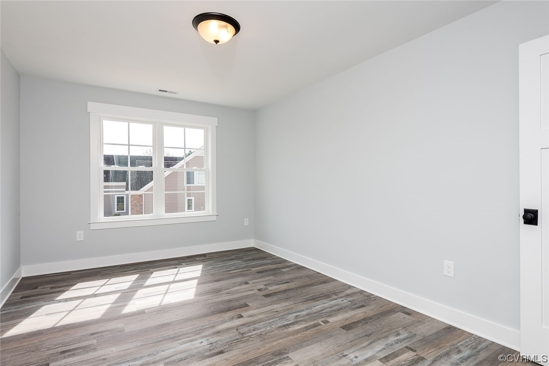 3154 Cider House Road Toano, VA 23168 - Photo 30 of 36 an empty room with wooden floor and windows