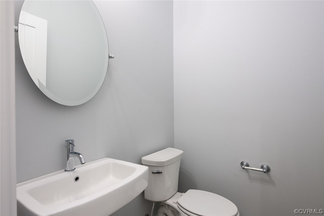 3154 Cider House Road Toano, VA 23168 - Photo 8 of 36 a white toilet sitting next to a white sink