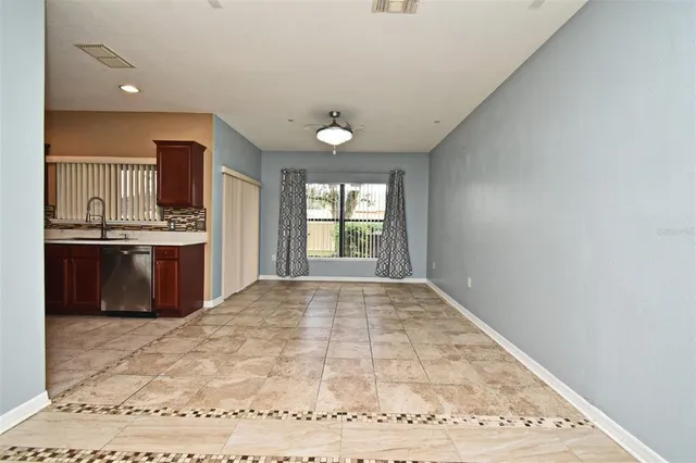 a view of kitchen with stainless steel appliances granite countertop a stove top oven a sink dishwasher and granite countertops