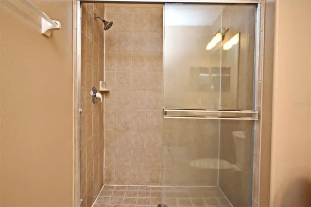 a bathroom with a glass shower door