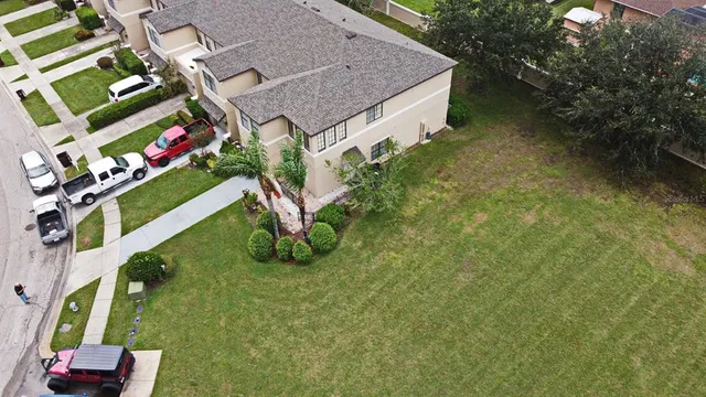 a aerial view of a house with a yard
