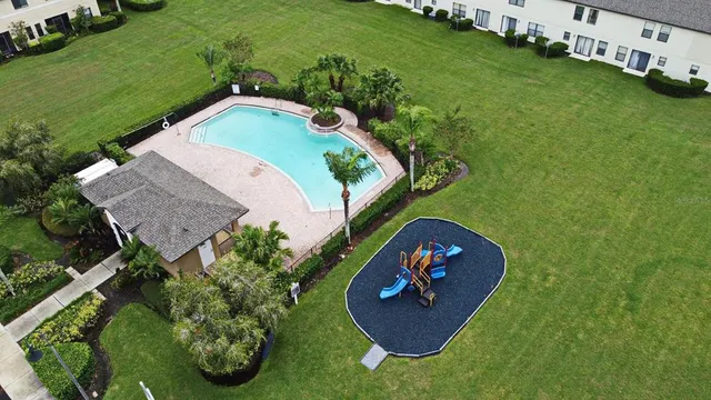 an aerial view of a house with a yard and lake view