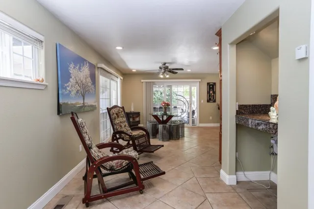 a living room with furniture and a potted plant
