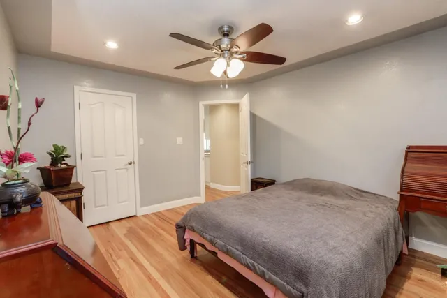 a bedroom with furniture and a wooden floor