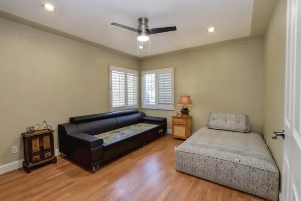 a bedroom with furniture and a wooden floor