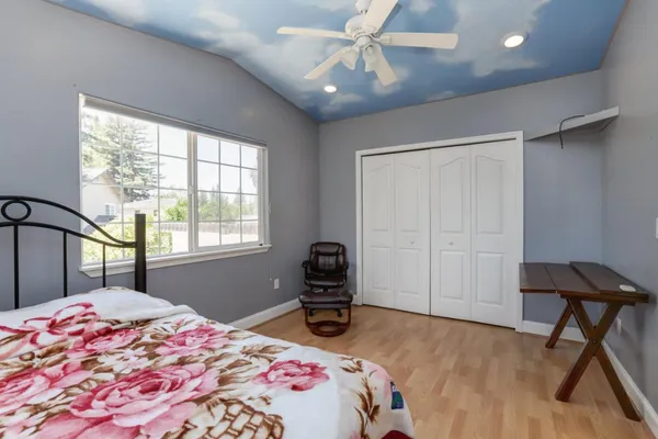 a bedroom with a bed and a chandelier