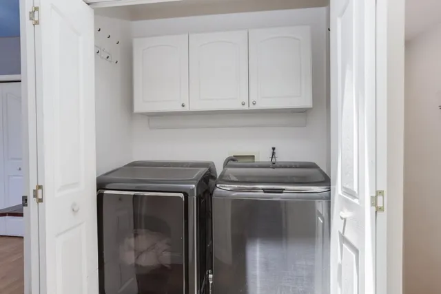 a view of a patio with table and chairs and wooden fence