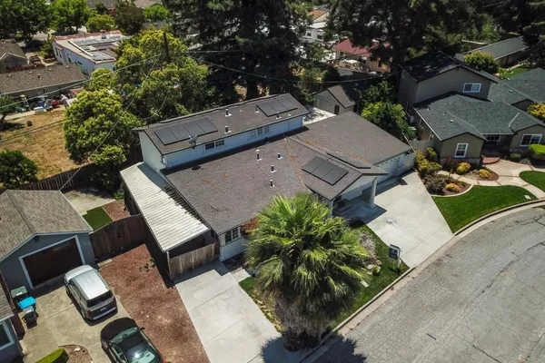 an aerial view of a house with garden space and sitting space