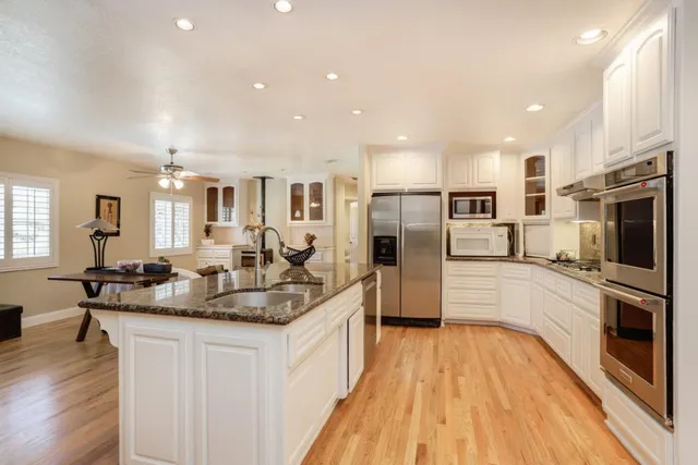 a large kitchen with stainless steel appliances kitchen island granite countertop a large counter top stainless steel appliances and cabinets