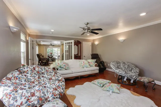 a living room with furniture and wooden floor