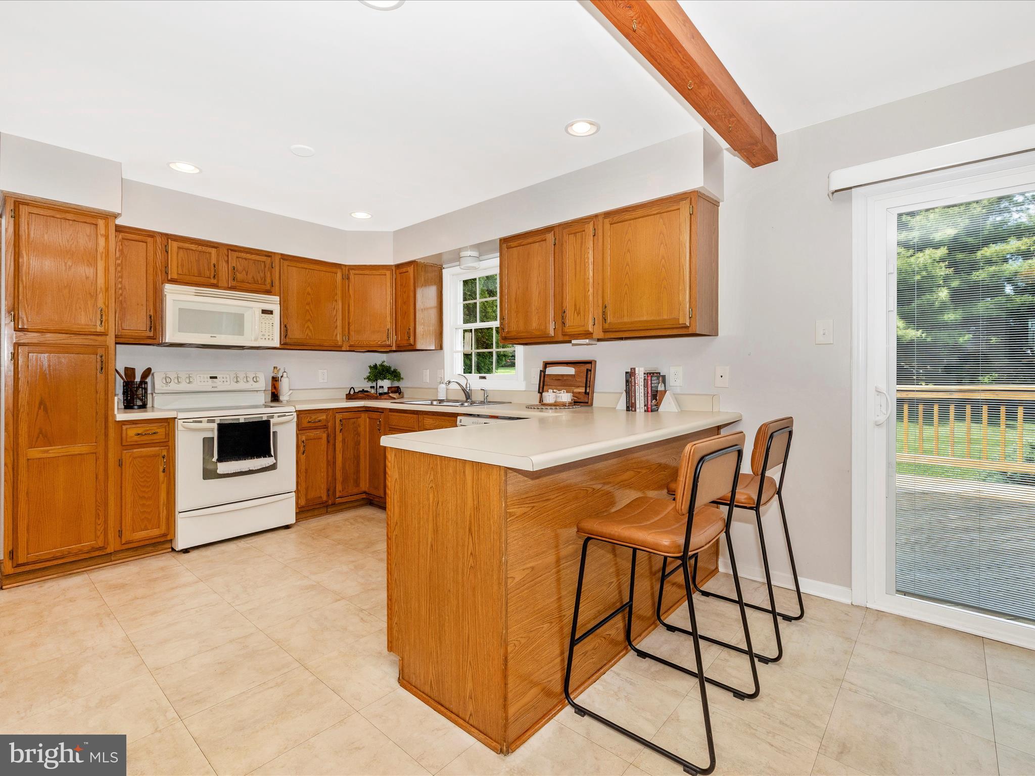 4503 Bartholows Road Mount Airy, MD 21771 - Photo 14 of 65 a kitchen with stainless steel appliances granite countertop a stove a sink a refrigerator with a dining table and chairs