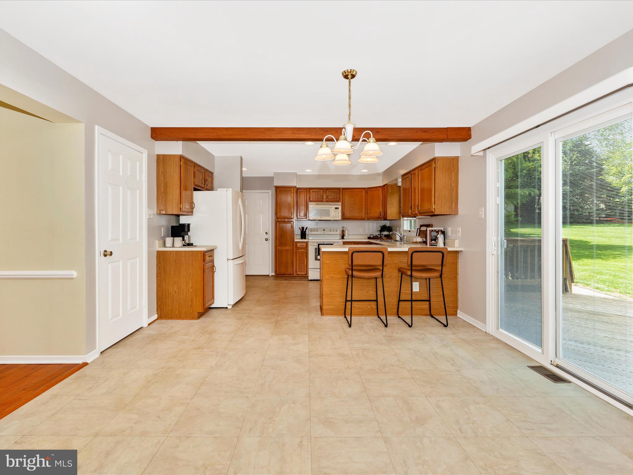 4503 Bartholows Road Mount Airy, MD 21771 - Photo 19 of 65 a kitchen with stainless steel appliances kitchen island granite countertop dining table chairs and a large window