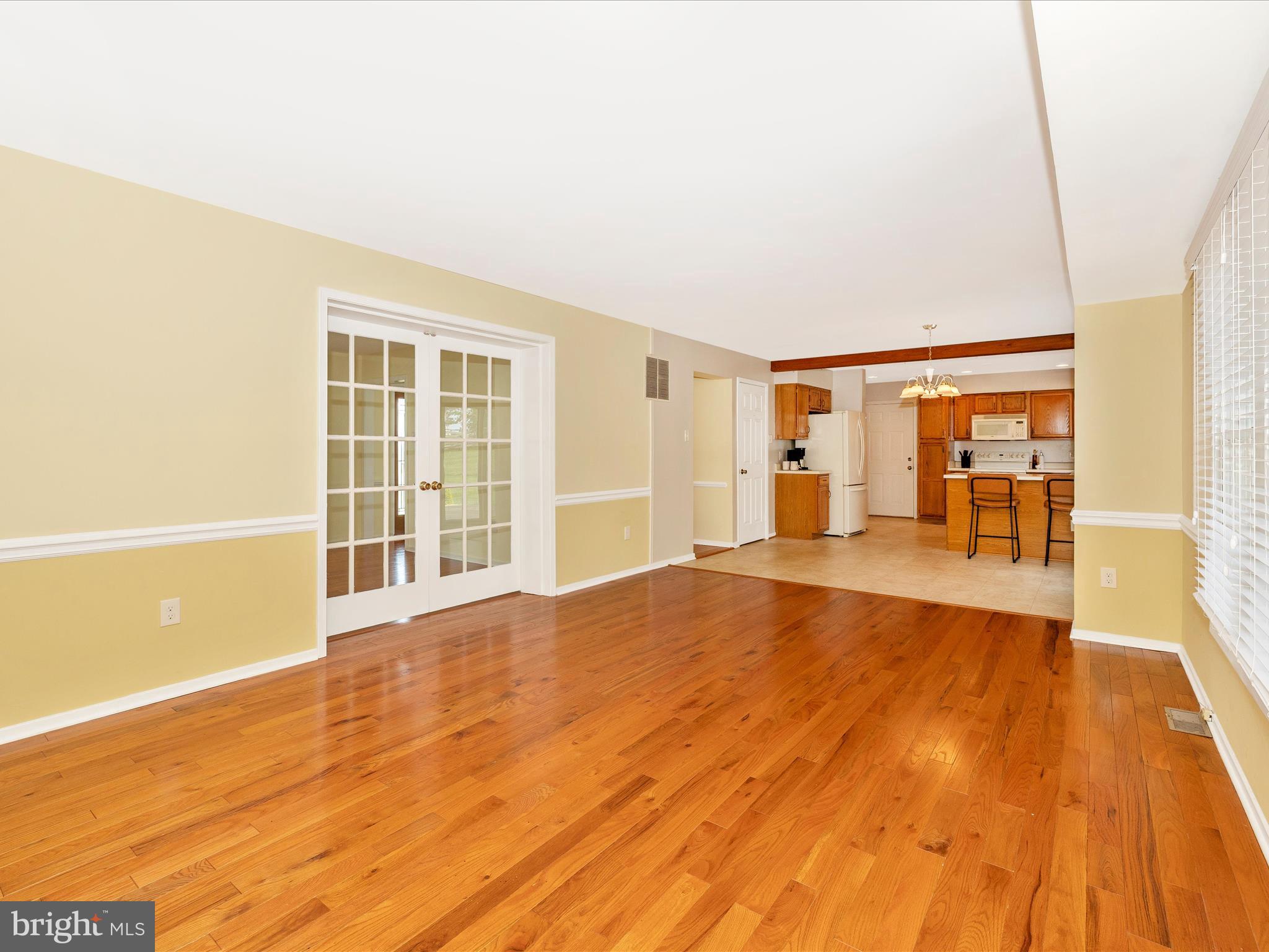 4503 Bartholows Road Mount Airy, MD 21771 - Photo 22 of 65 a view of an empty room with wooden floor and a window