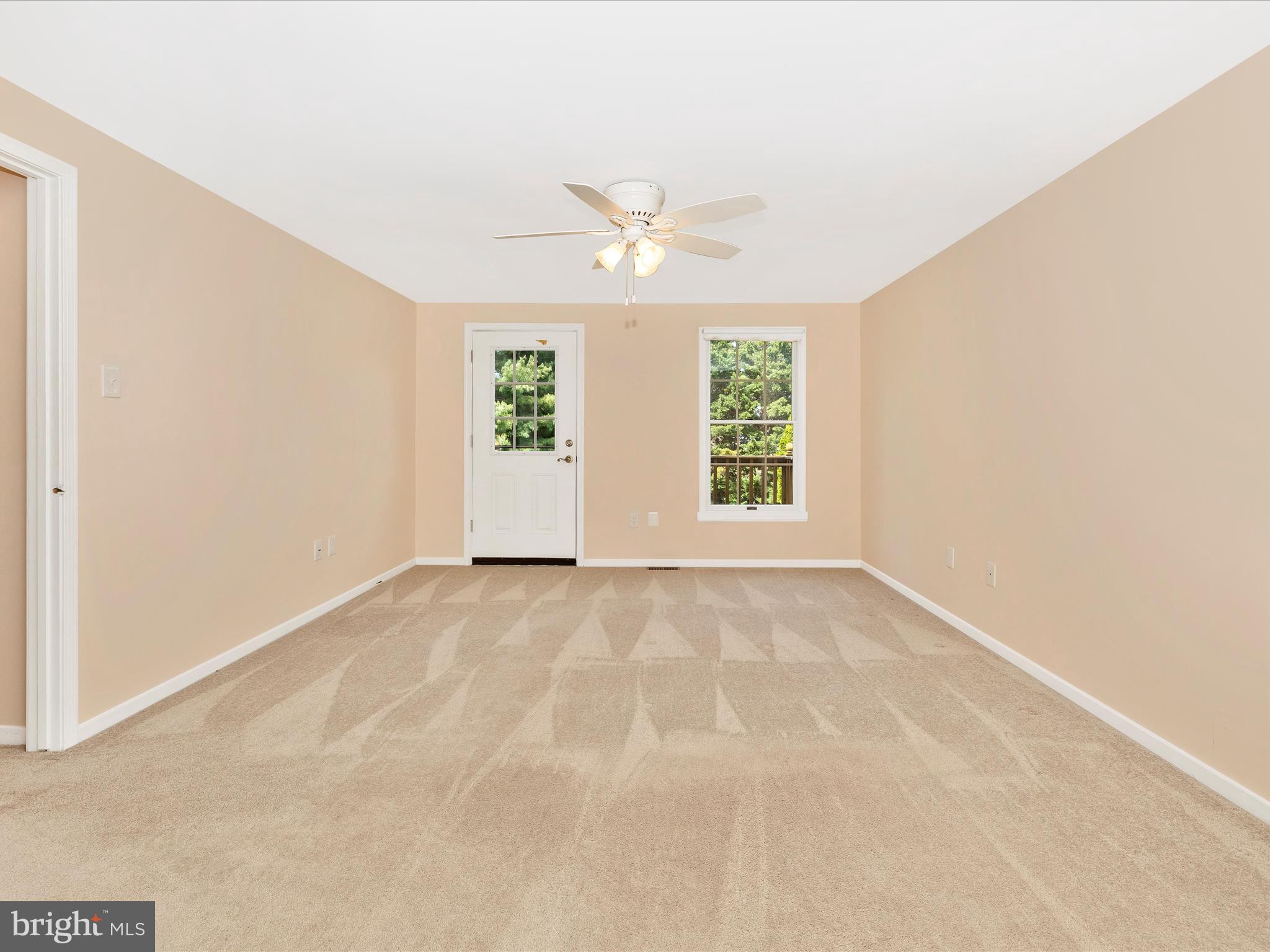 4503 Bartholows Road Mount Airy, MD 21771 - Photo 24 of 65 an empty room with windows and ceiling fan