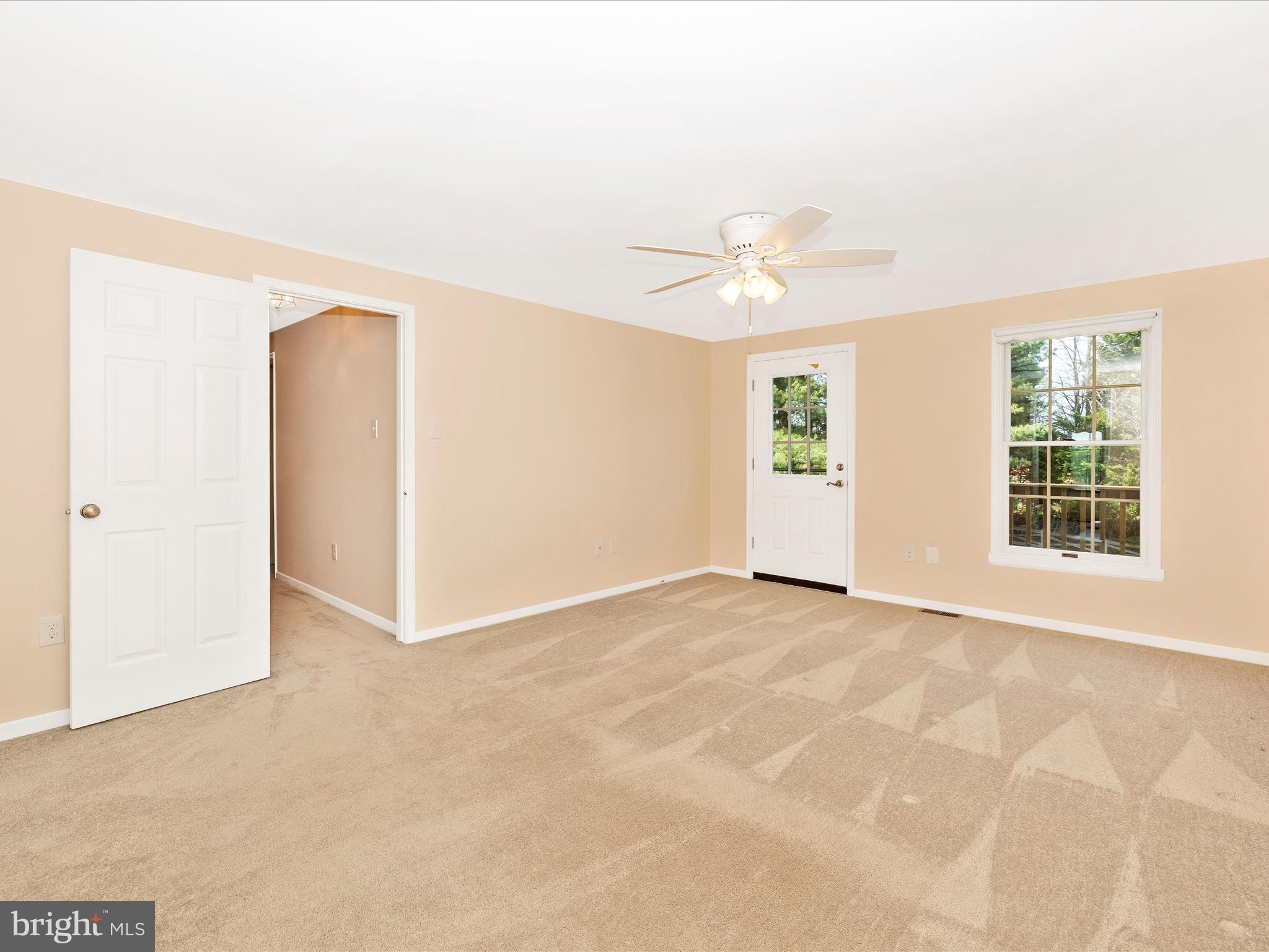 4503 Bartholows Road Mount Airy, MD 21771 - Photo 25 of 65 an empty room with windows and ceiling fan