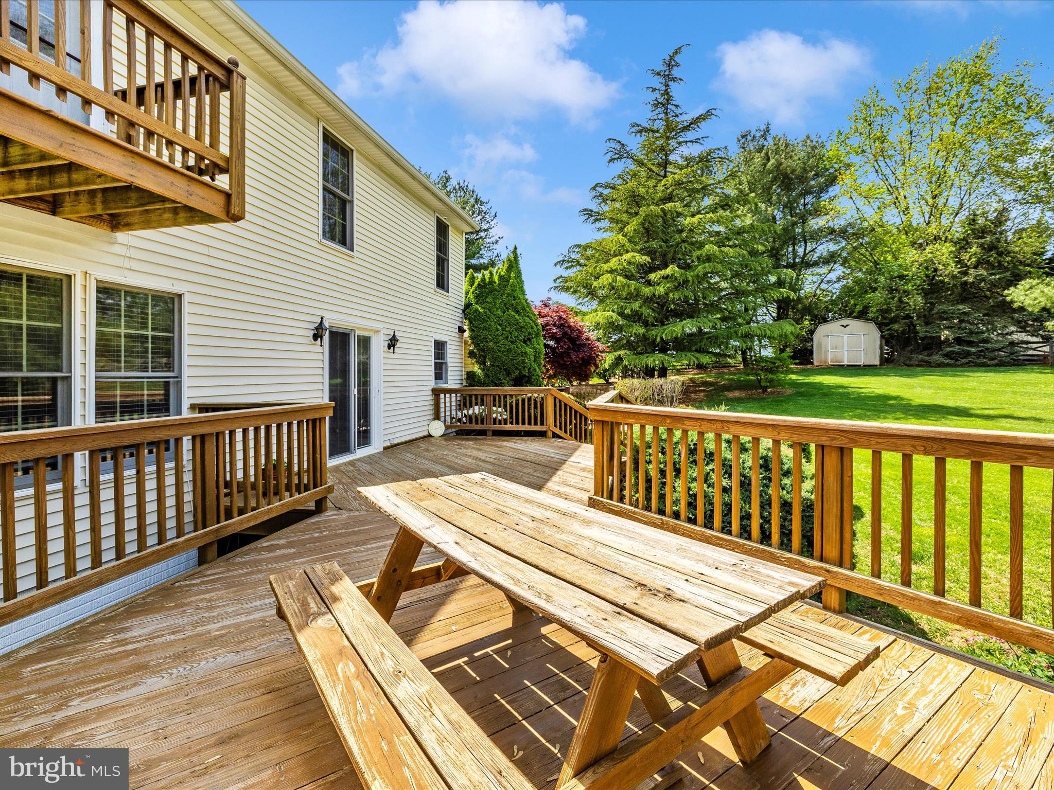 4503 Bartholows Road Mount Airy, MD 21771 - Photo 51 of 65 a view of a deck with wooden floor and fence with a bench