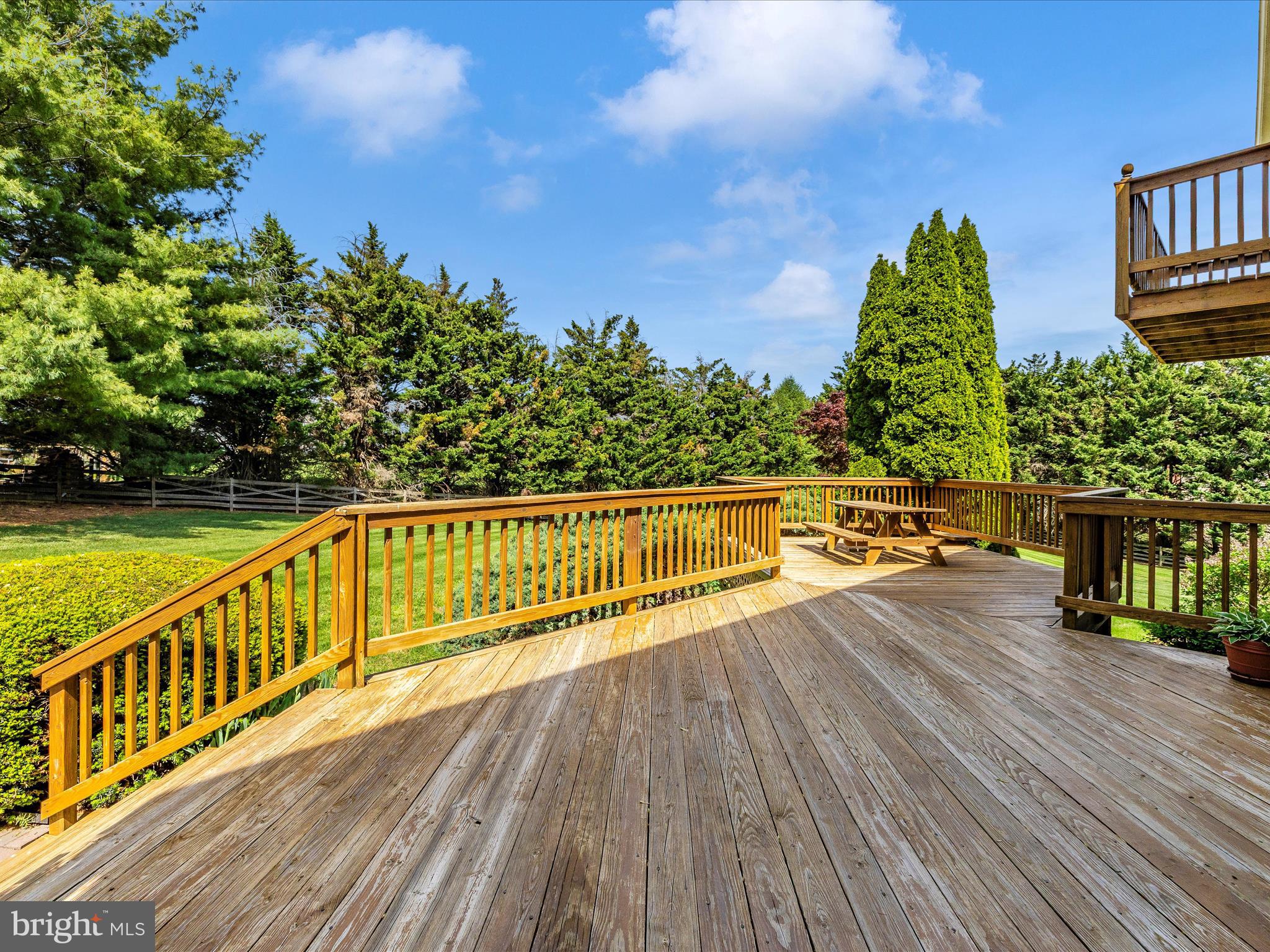 4503 Bartholows Road Mount Airy, MD 21771 - Photo 6 of 65 a view of a balcony with wooden floor and fence